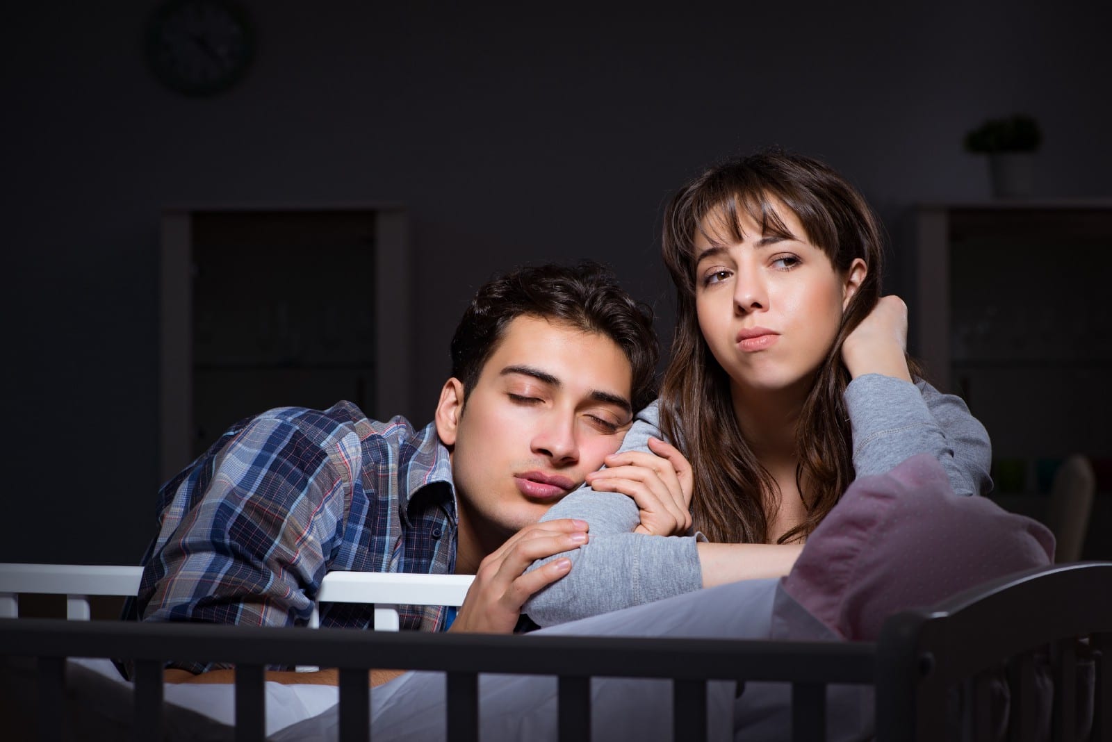 Tired Parents Sleeping on Crib