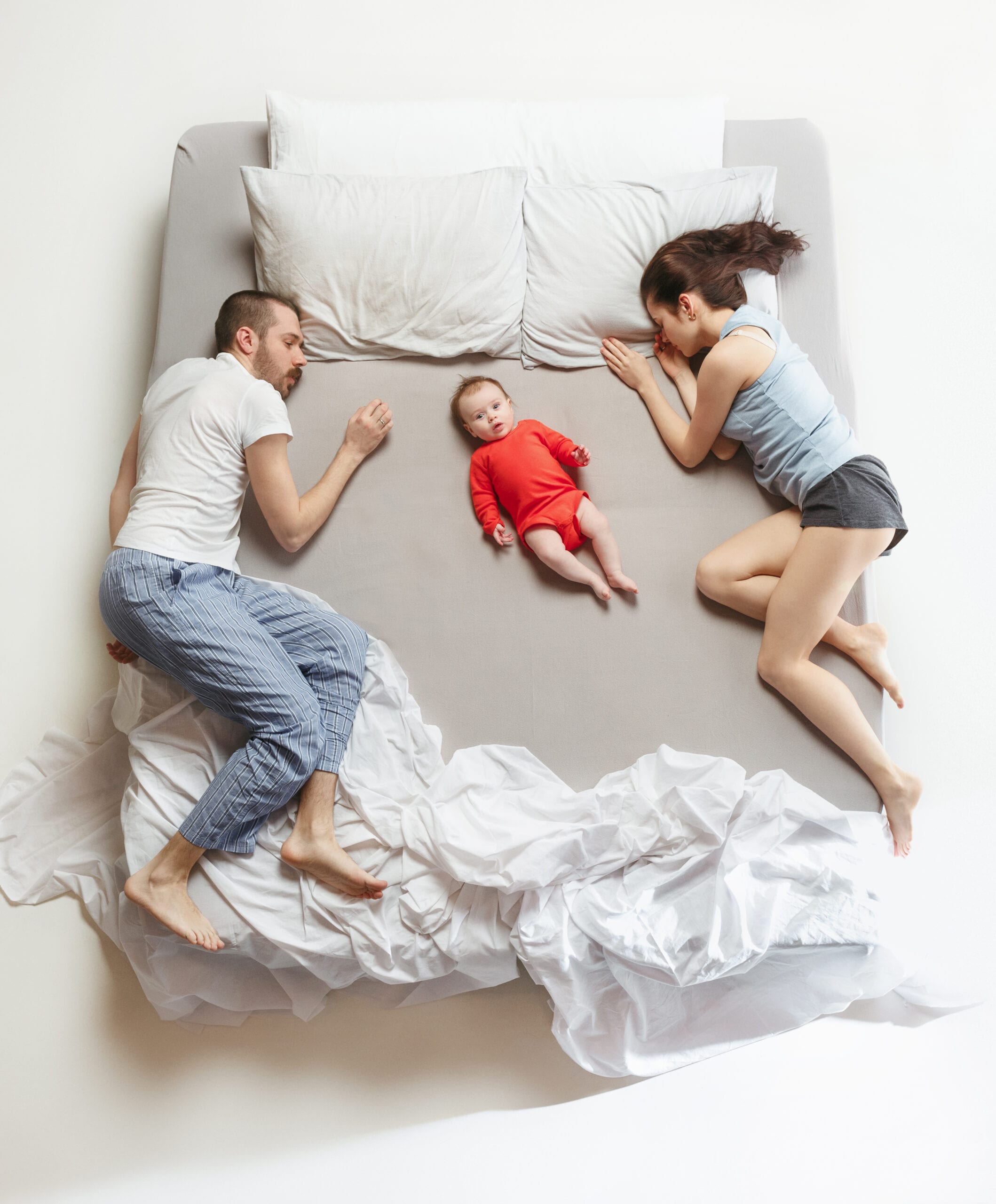 mom and dad in bed with baby