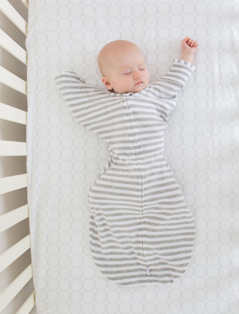 At what age can a baby sleep on their stomach?